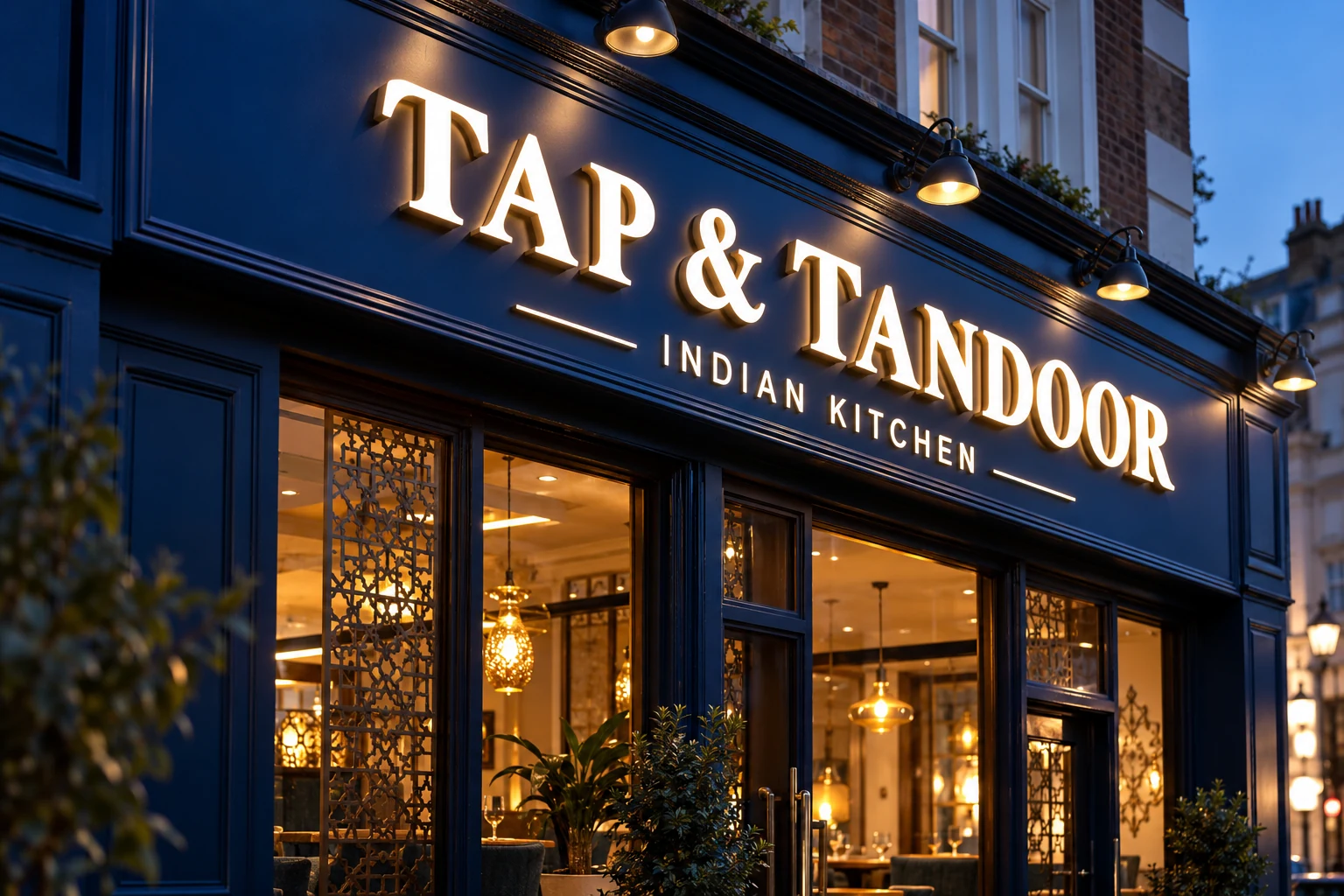 Illuminated restaurant fascia at dusk